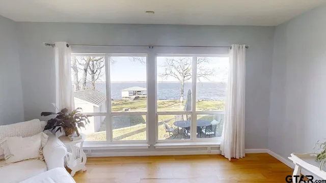a living room with a large window and a table