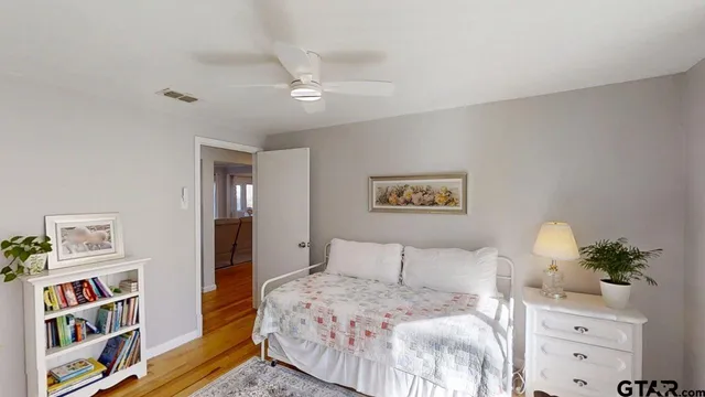 a bedroom with a bed and a bookshelf