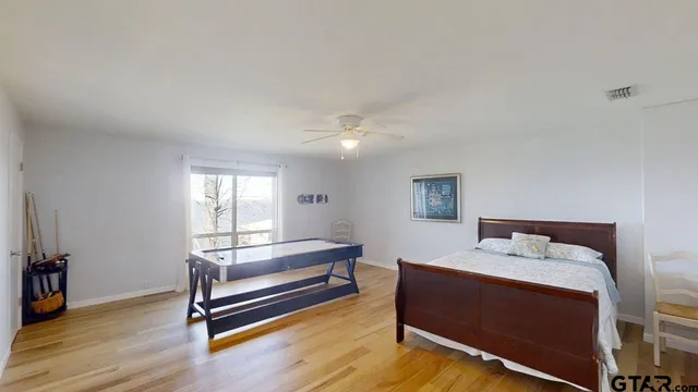 a bedroom with furniture and wooden floor