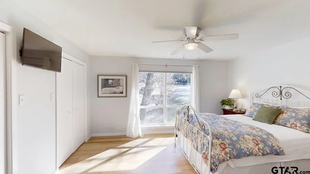 a bedroom with a large bed and a chandelier