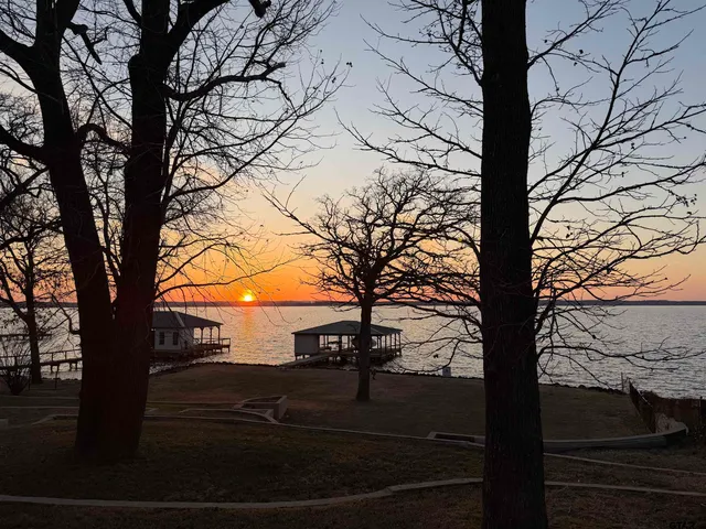 a view of wooden house with a yard