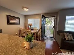 a living room with furniture flowerpot and wooden floor