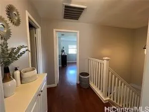 a view of a hallway to a livingroom with furniture