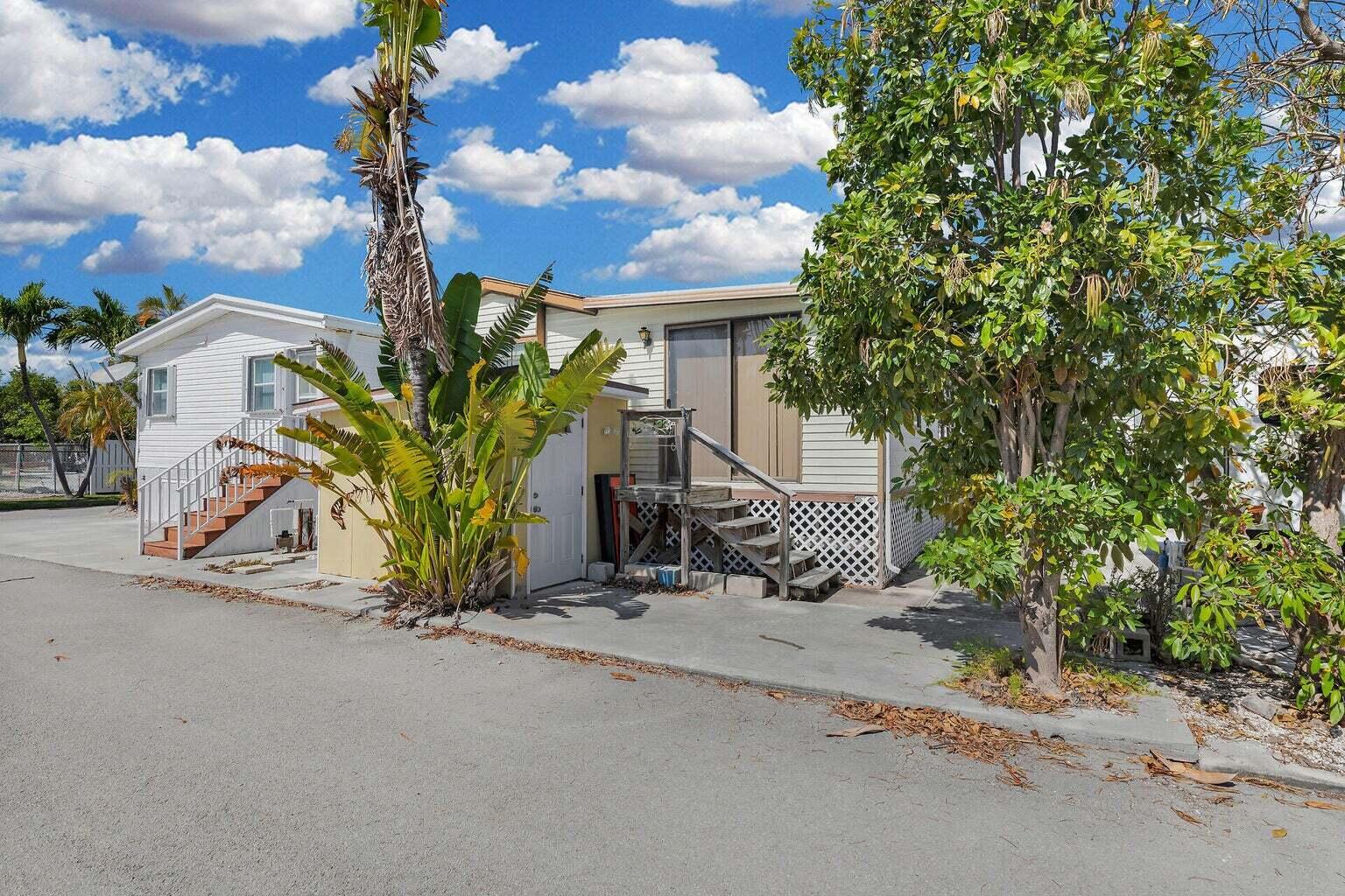55 Boca Chica Road, Unit 85 Key West, FL 33040 - Photo 11 of 47 a view of a house with potted plants and large trees