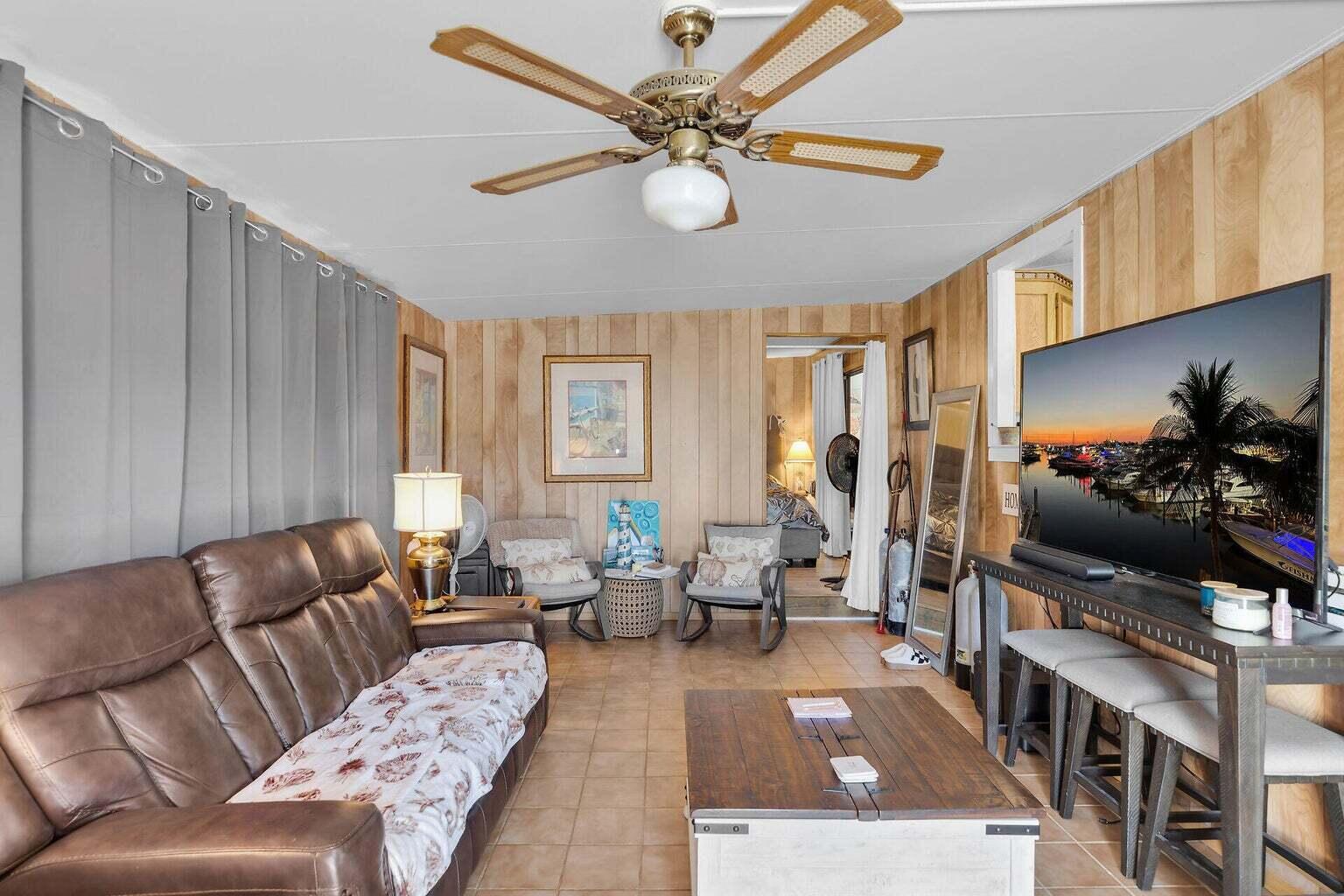 55 Boca Chica Road, Unit 85 Key West, FL 33040 - Photo 21 of 47 a living room with furniture and a flat screen tv