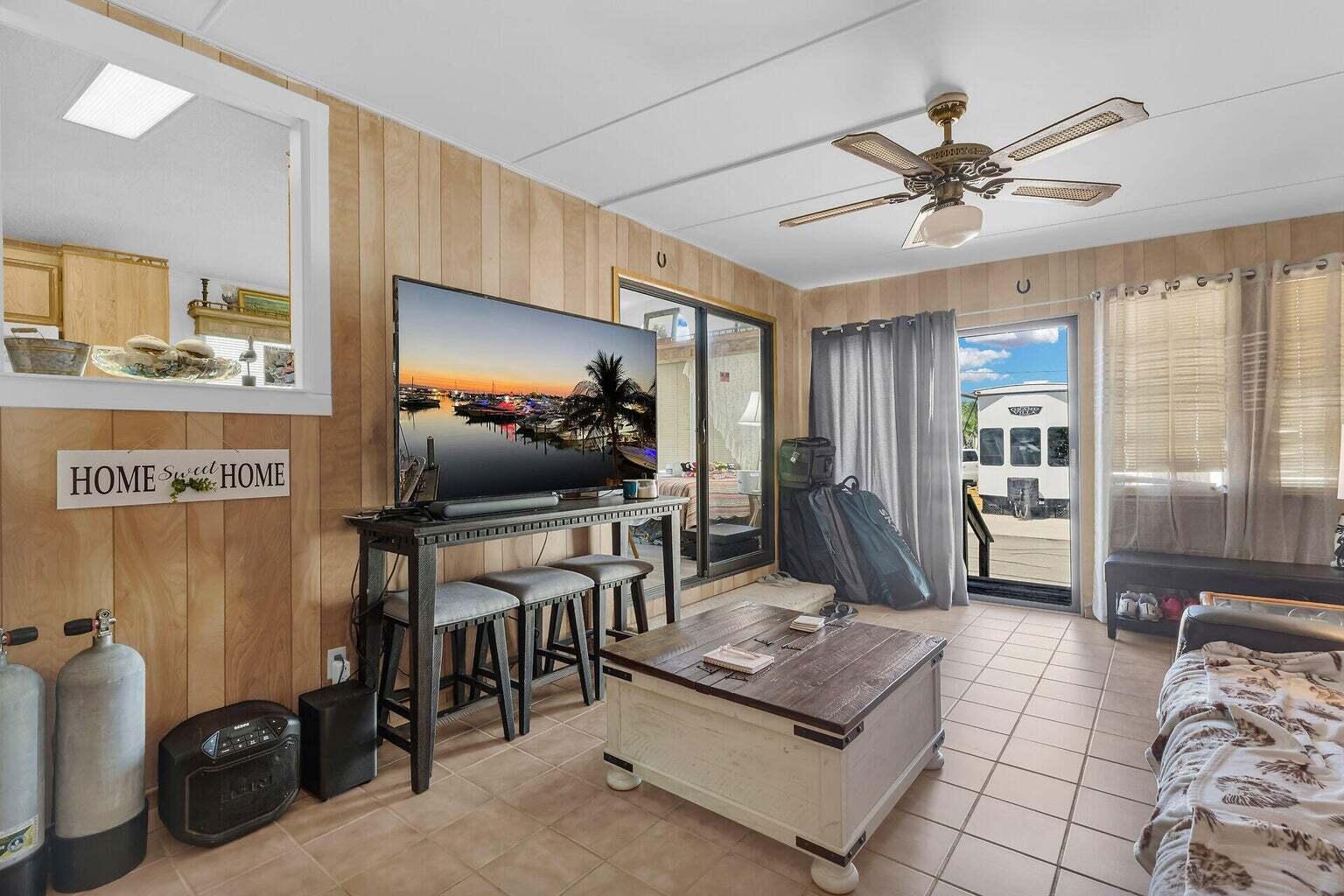 55 Boca Chica Road, Unit 85 Key West, FL 33040 - Photo 23 of 47 a living room with furniture and a flat screen tv
