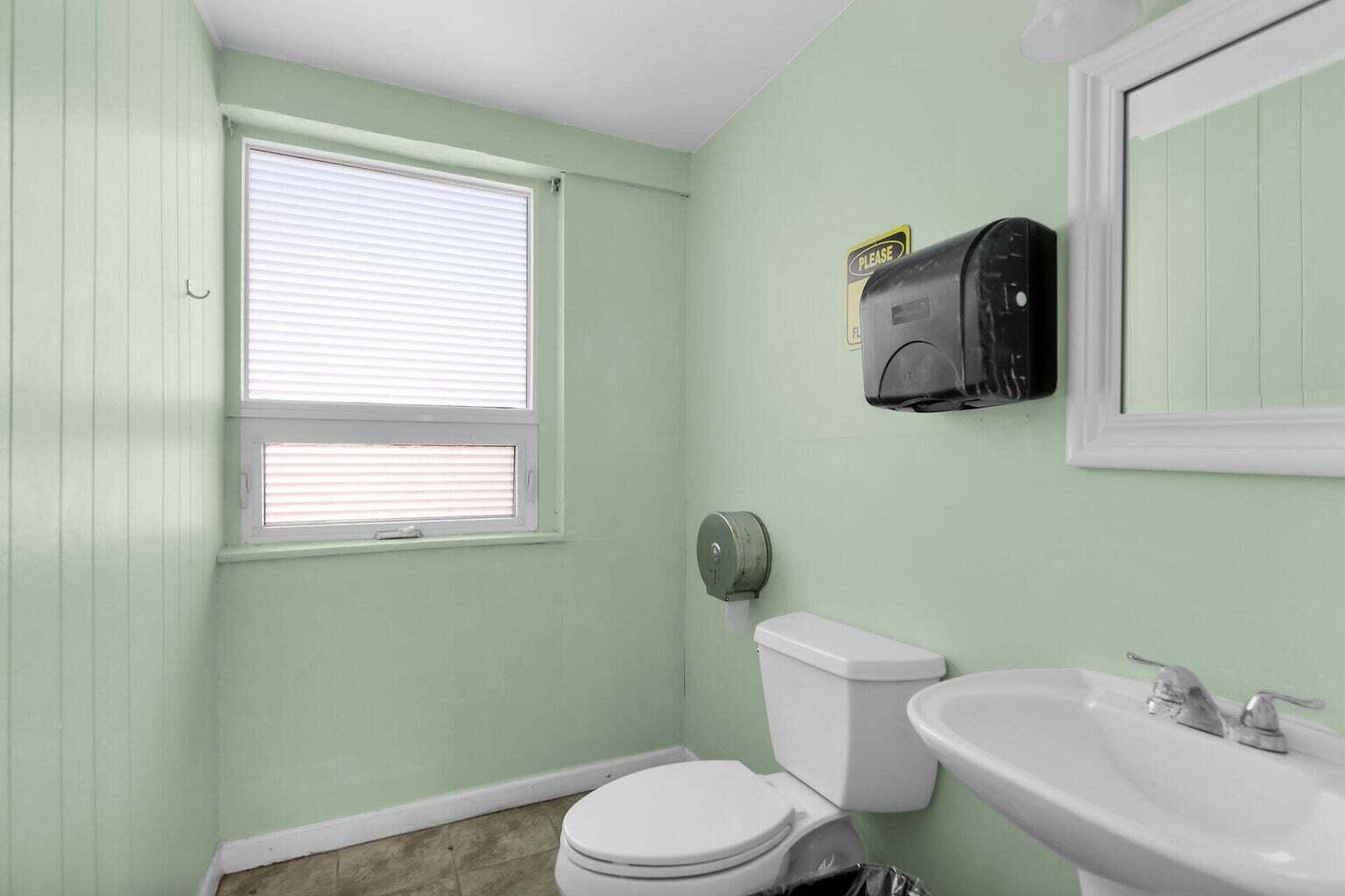 55 Boca Chica Road, Unit 85 Key West, FL 33040 - Photo 26 of 47 a bathroom with a toilet sink and mirror