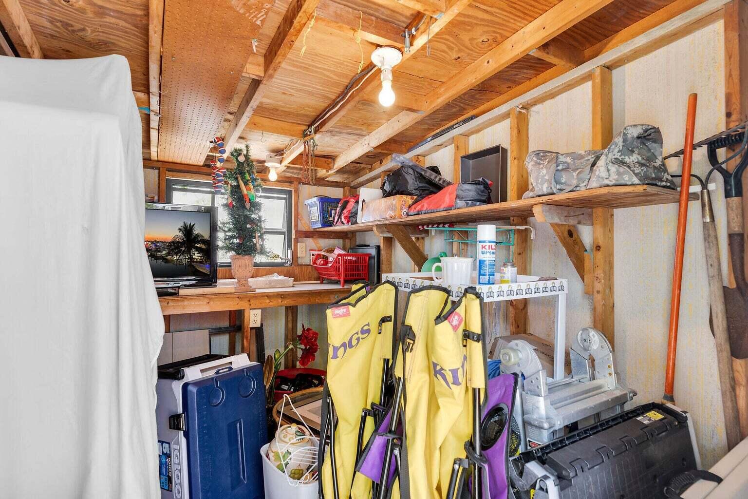 55 Boca Chica Road, Unit 85 Key West, FL 33040 - Photo 45 of 47 a view of walk in closet with clothes and shoes