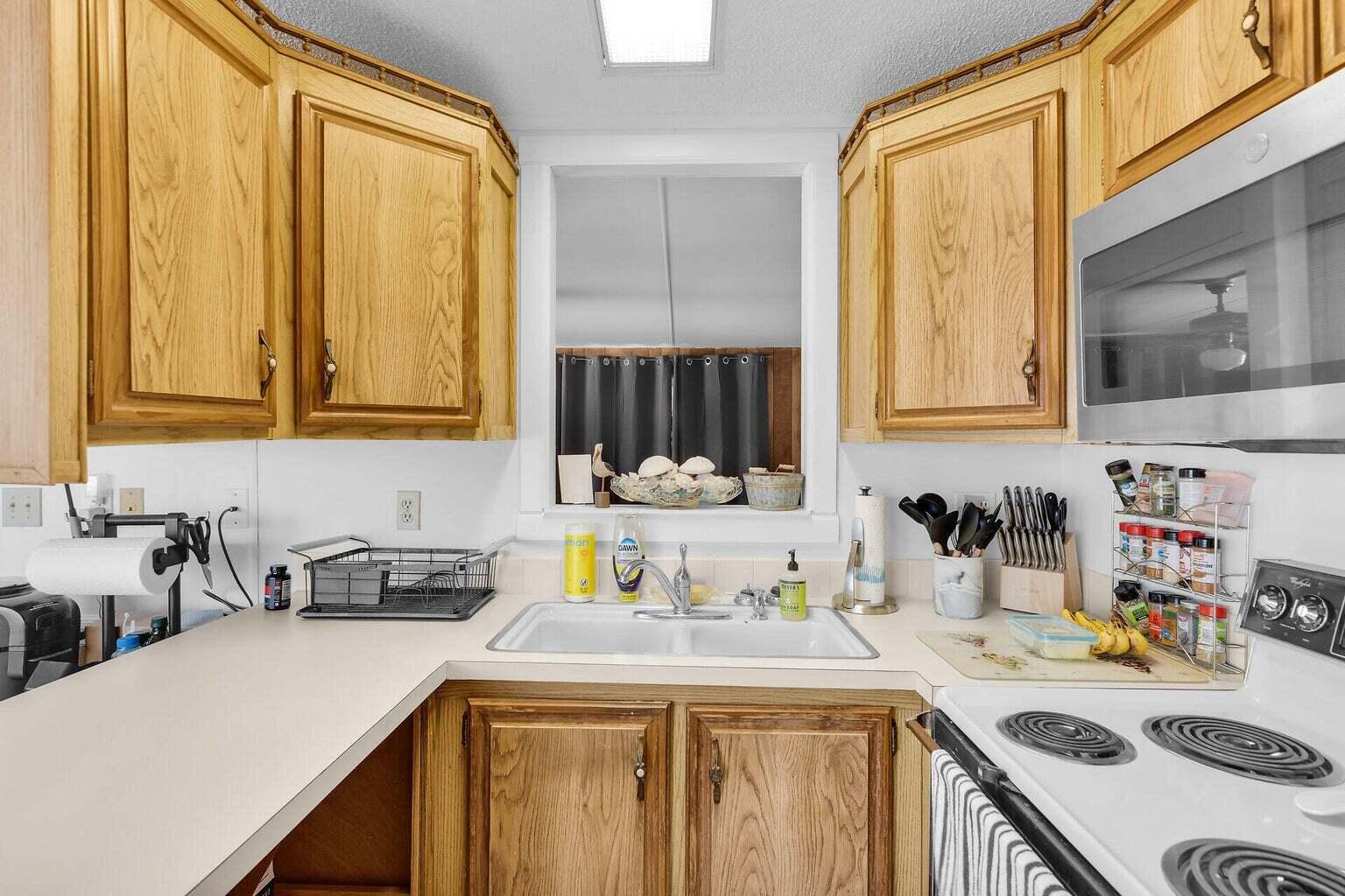 55 Boca Chica Road, Unit 85 Key West, FL 33040 - Photo 5 of 47 a kitchen with a sink a stove and cabinets