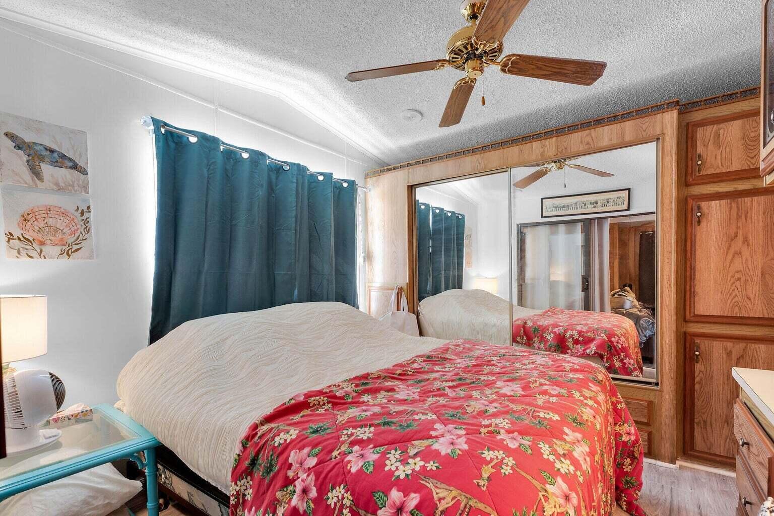 55 Boca Chica Road, Unit 85 Key West, FL 33040 - Photo 8 of 47 a bedroom with two beds and a chandelier