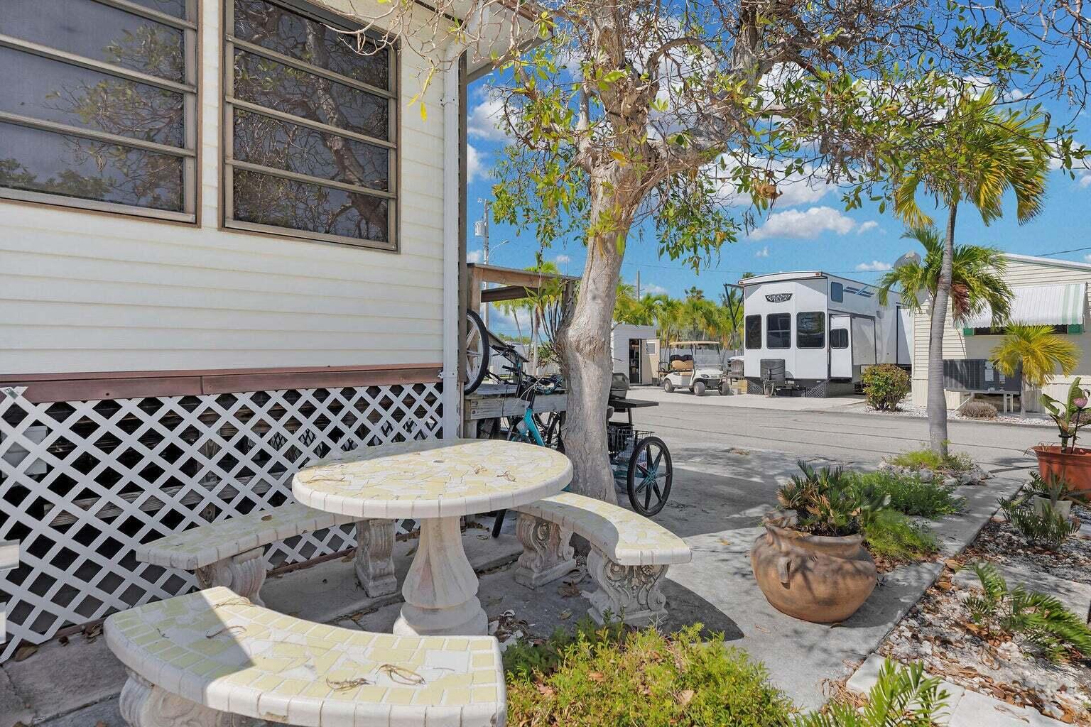 55 Boca Chica Road, Unit 85 Key West, FL 33040 - Photo 10 of 47 a view of a patio with table and chairs potted plants