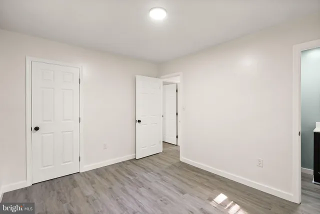 a view of an empty room and wooden floor