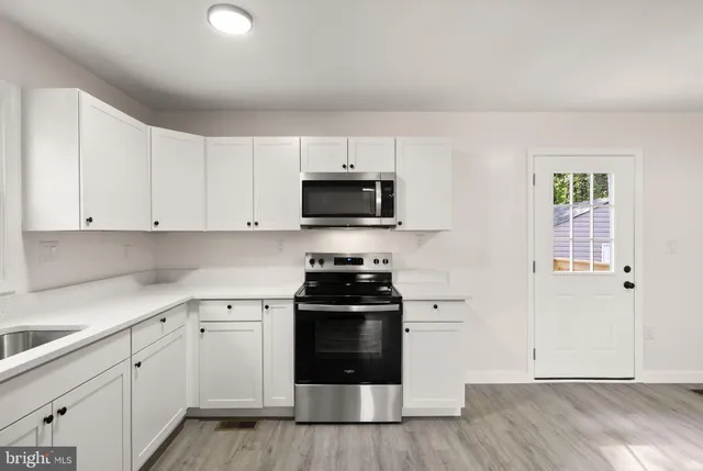 a kitchen with a stove and a sink