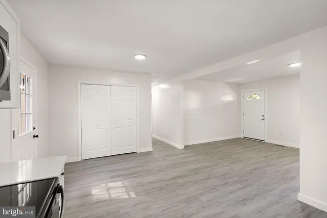a view of an empty room with wooden floor