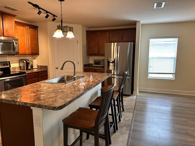 a dining table with chairs and wooden floor