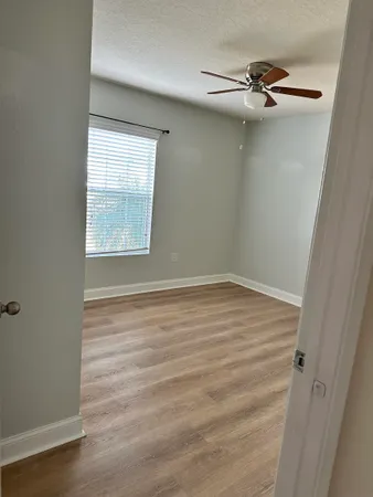 an empty room with windows and closet