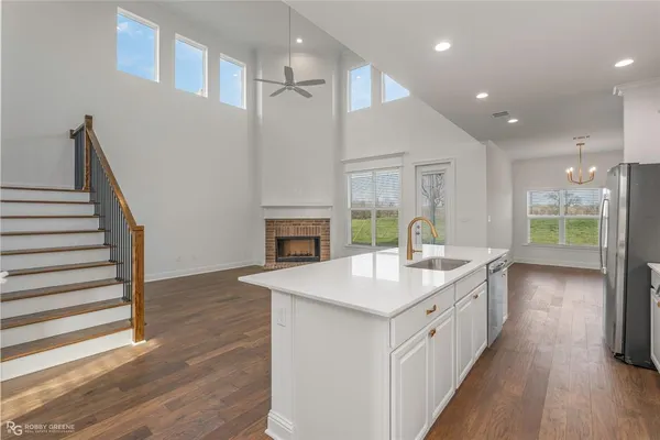 a kitchen with sink cabinets and wooden floor