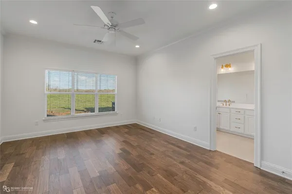 an empty room with wooden floor and a window