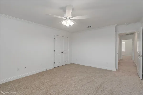 a view of an empty room with a ceiling fan