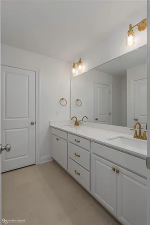 a spacious bathroom with double sink two mirror and a vanity