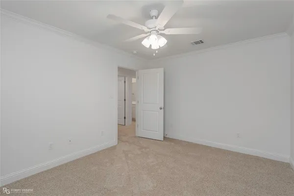 a view of an empty room with a ceiling fan