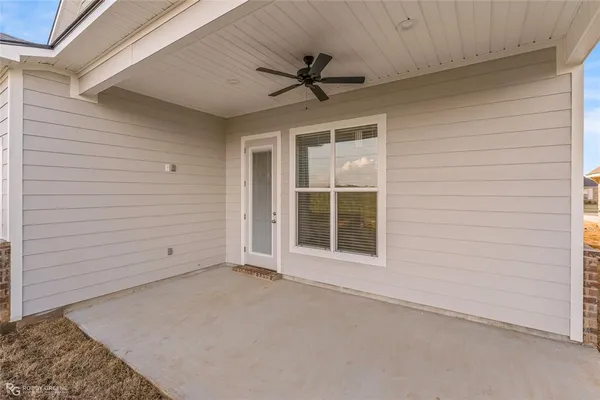 a view of an empty room with a ceiling fan