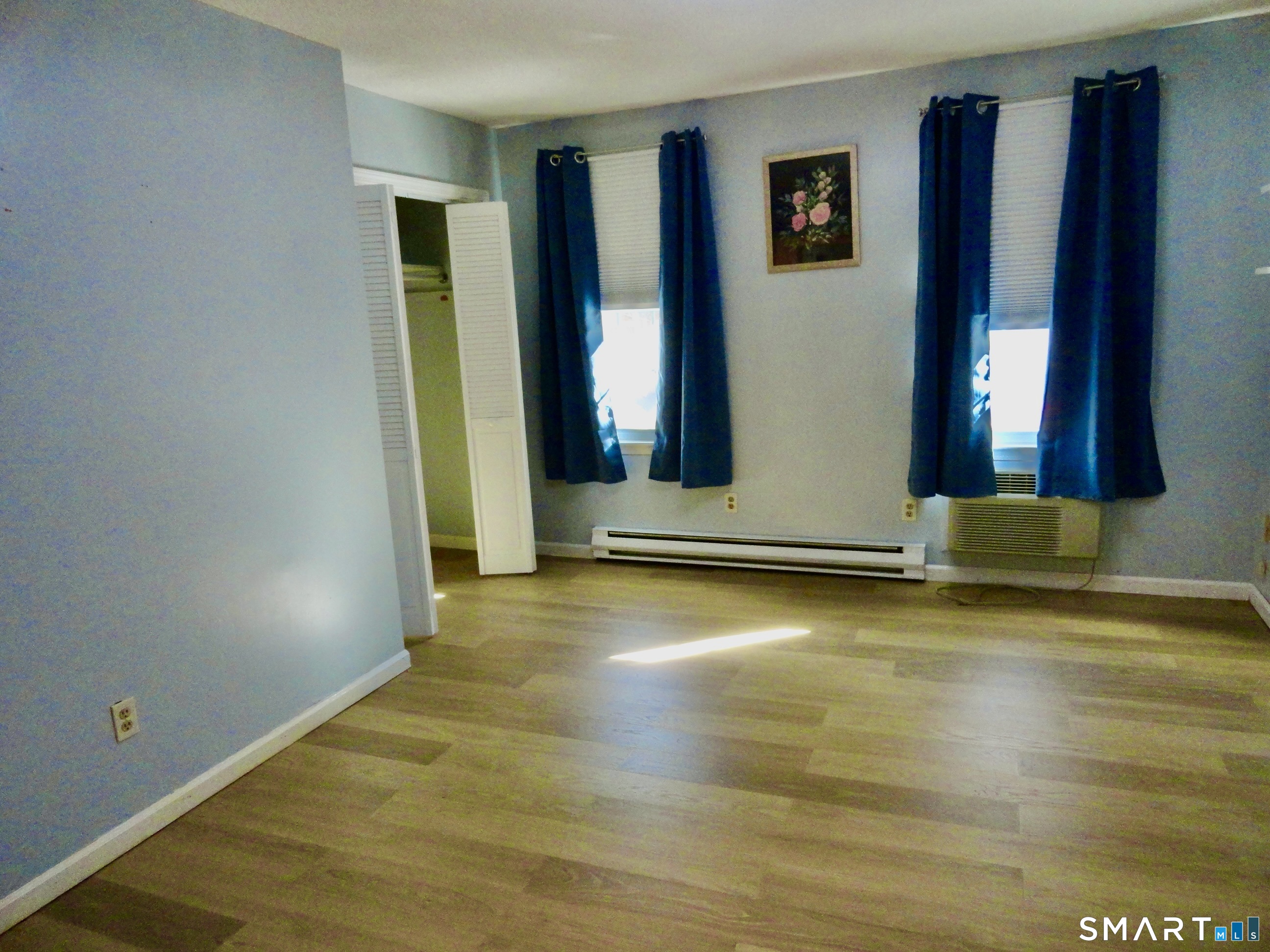 79 Hunter Court, Unit 79 Torrington, CT 06790 - Photo 12 of 19 a view of an empty room with window and wooden floor
