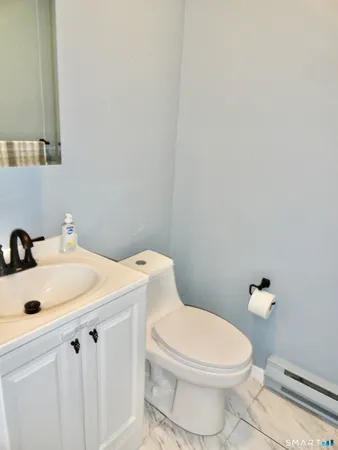 a white toilet sitting next to a bathroom sink