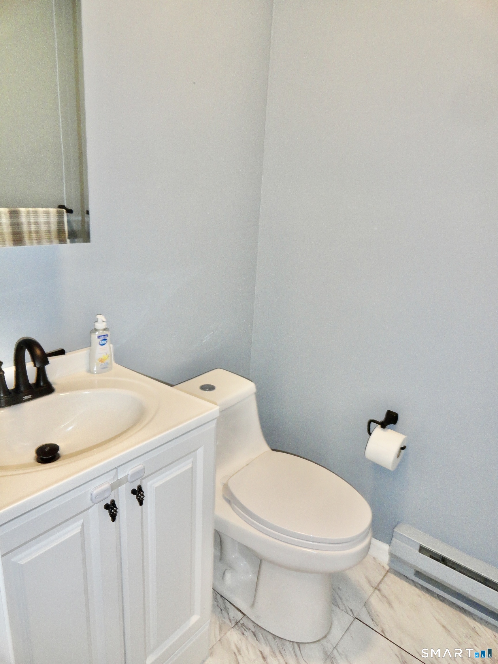 79 Hunter Court, Unit 79 Torrington, CT 06790 - Photo 9 of 19 a white toilet sitting next to a bathroom sink