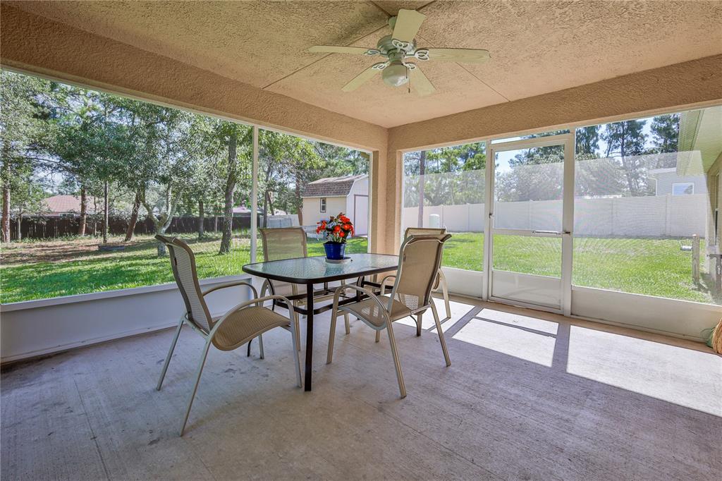 11213 Flock Avenue Weeki Wachee, FL 34613 - Photo 38 of 46 a dining room with furniture and a garden view