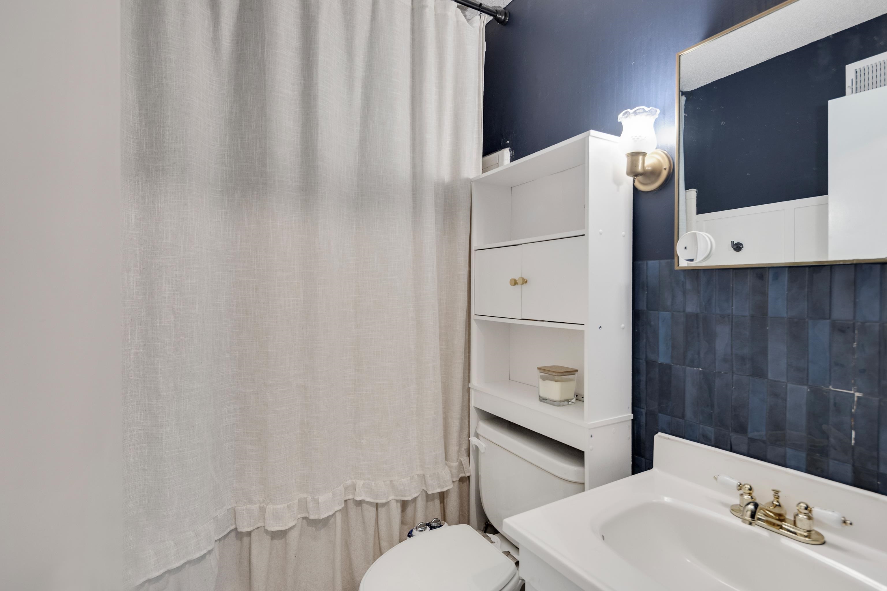 1137 Greenview Road Collierville, TN 38017 - Photo 20 of 35 a bathroom with a sink and a mirror