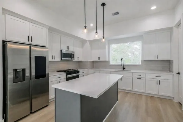 a kitchen with a stove and a microwave