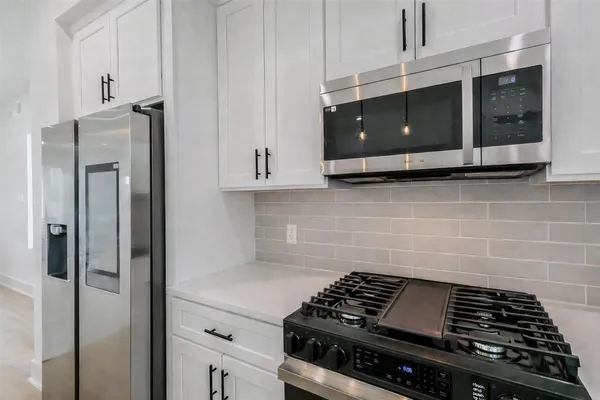 a kitchen with a sink stove and cabinets