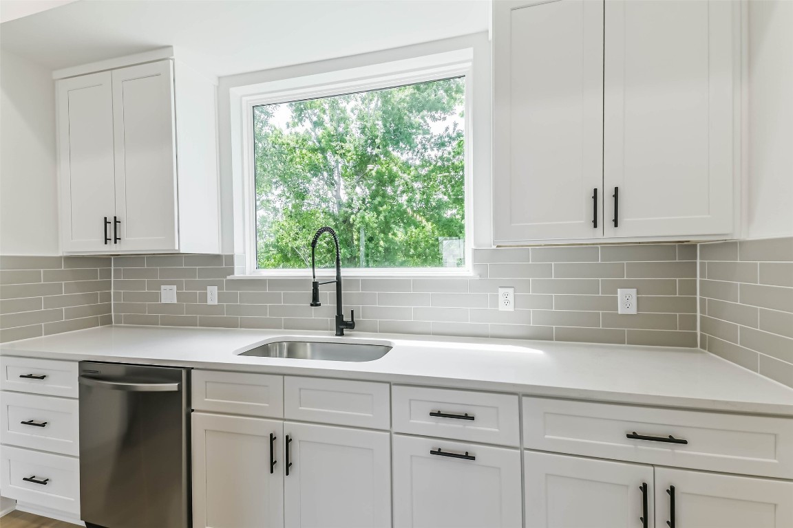 5703 Balbo Street, Unit F Houston, TX 77091 - Photo 18 of 39 a kitchen with a sink and cabinets
