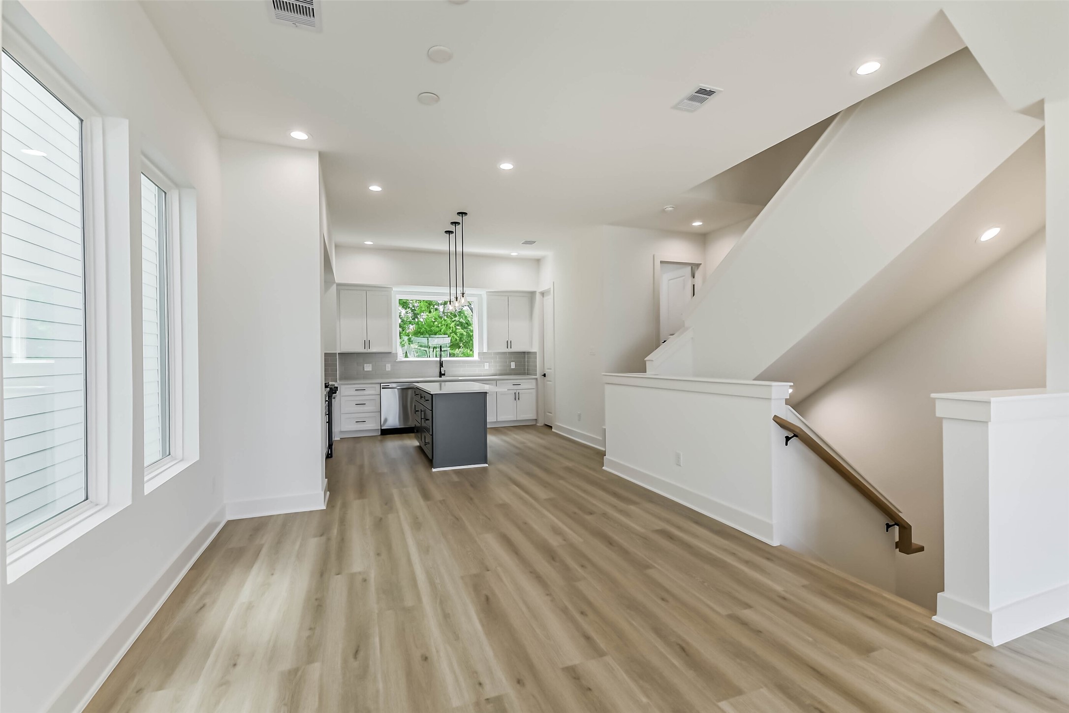 5703 Balbo Street, Unit F Houston, TX 77091 - Photo 20 of 39 a view of a living room kitchen with furniture and wooden floor