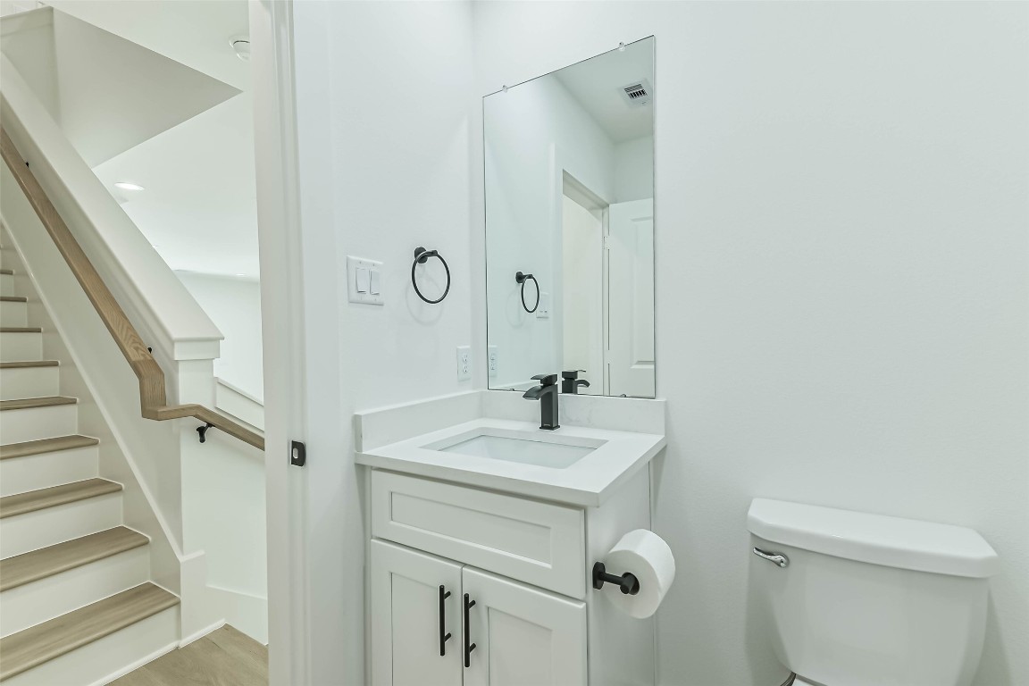 5703 Balbo Street, Unit F Houston, TX 77091 - Photo 23 of 39 a bathroom with a sink a toilet and shower