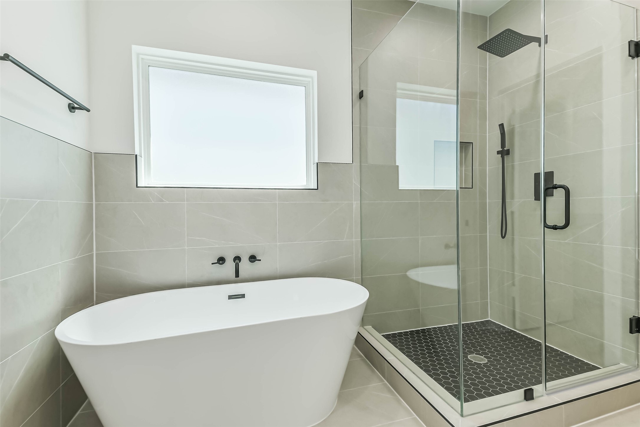 5703 Balbo Street, Unit F Houston, TX 77091 - Photo 30 of 39 a bathroom with a bathtub and a shower