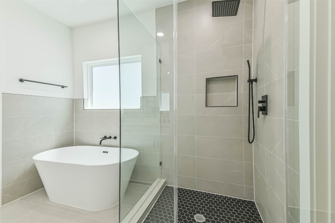 5703 Balbo Street, Unit F Houston, TX 77091 - Photo 31 of 39 a bathroom with a bathtub and shower