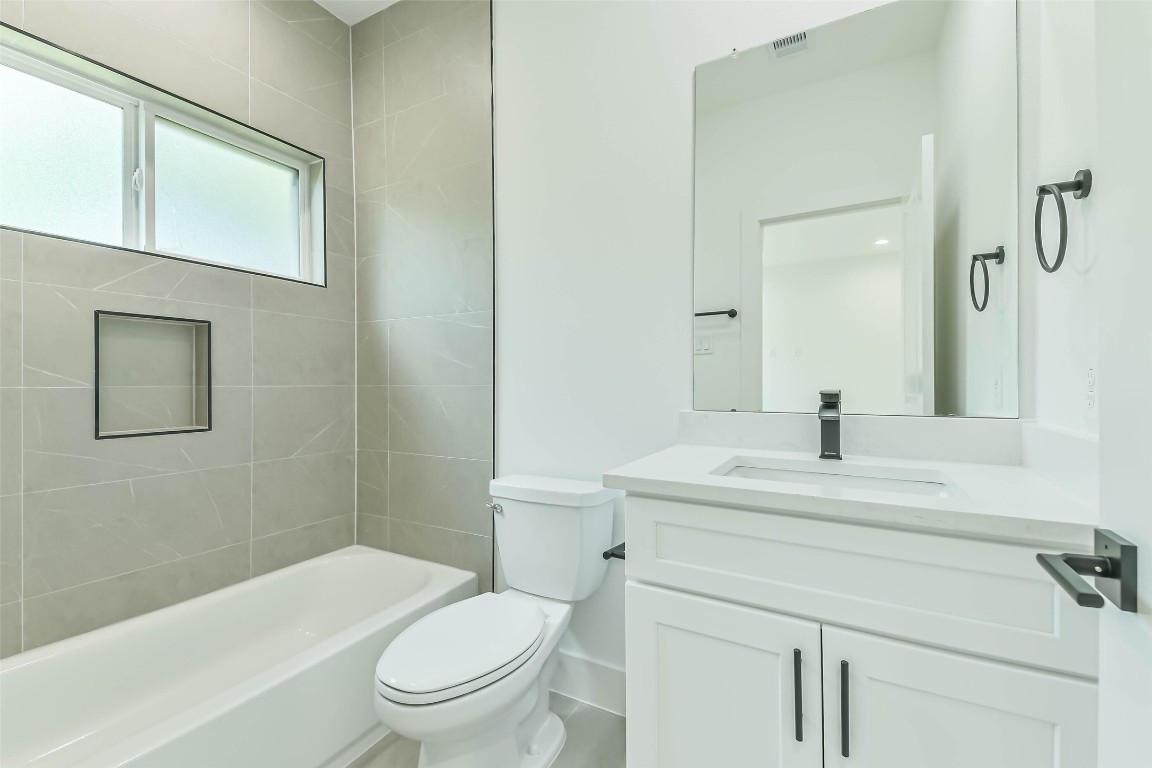 5703 Balbo Street, Unit F Houston, TX 77091 - Photo 36 of 39 a bathroom with a sink a toilet and shower