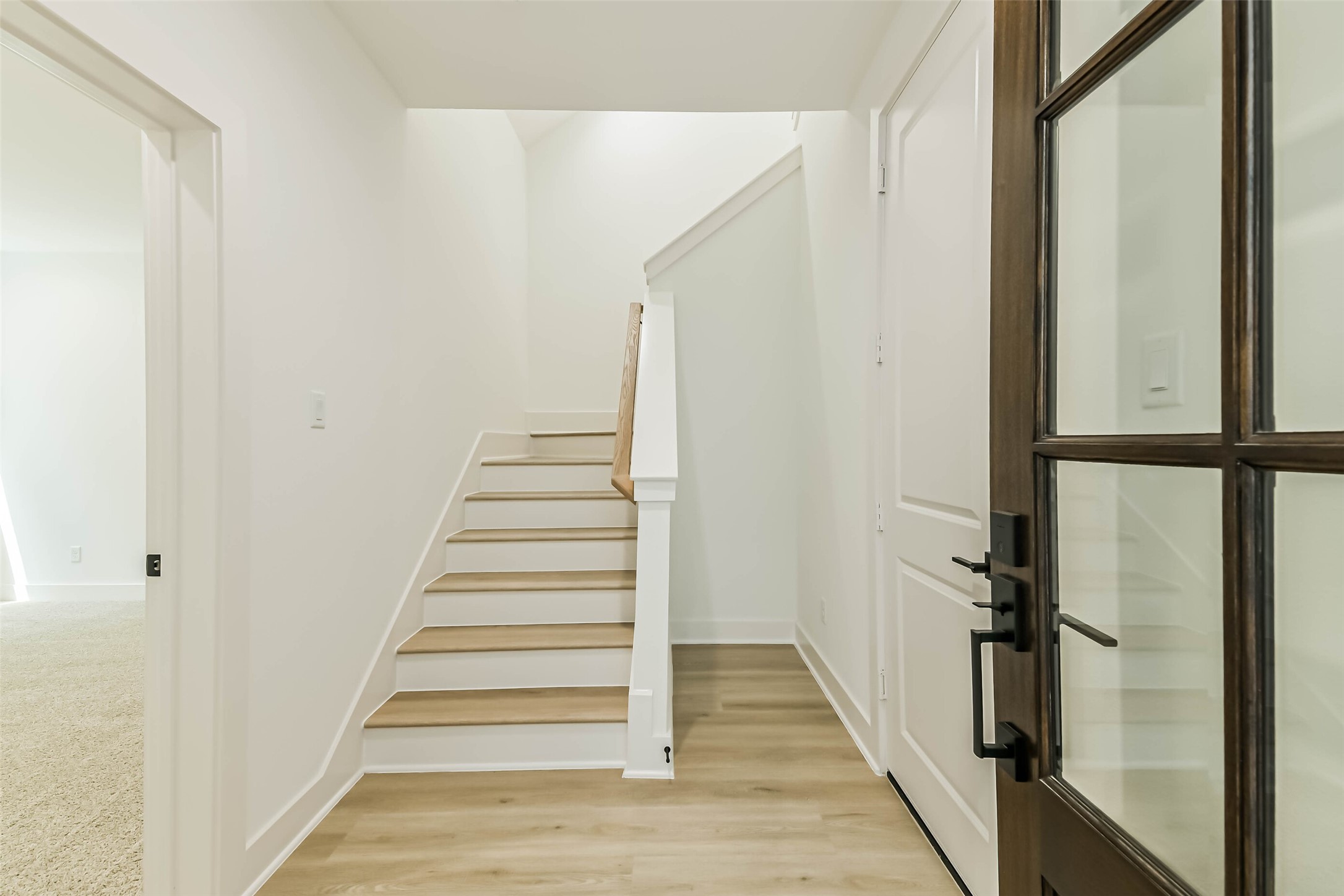 5703 Balbo Street, Unit F Houston, TX 77091 - Photo 6 of 39 a view of a hallway with wooden floor and staircase