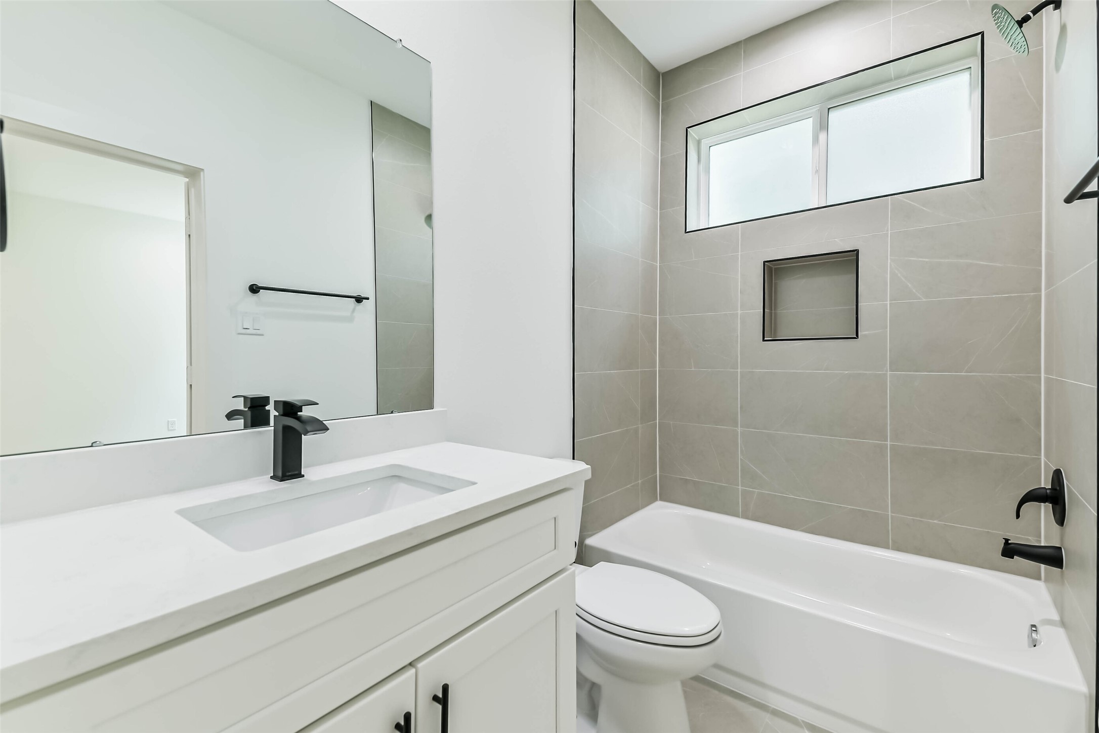 5703 Balbo Street, Unit F Houston, TX 77091 - Photo 10 of 39 a bathroom with a sink a toilet and shower