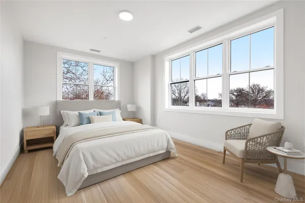 a room with a bed and a large window