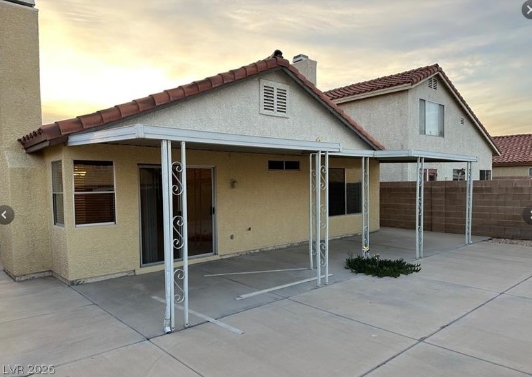 7652 Kalmalii Avenue Las Vegas, NV 89147 - Photo 8 of 9 A spacious covered patio extends from the home, offering ample outdoor living space.