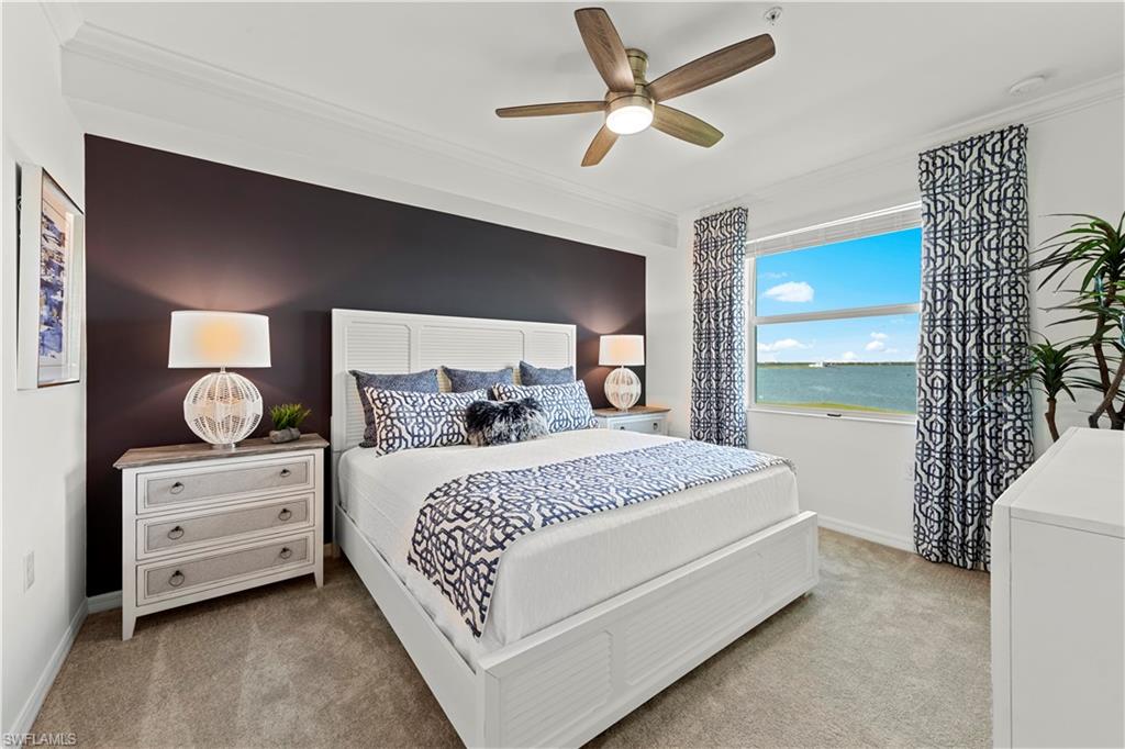 5715 Double Eagle Circle, Unit 4414 Immokalee, FL 34142 - Photo 13 of 20 a bedroom with a bed chandelier and a window