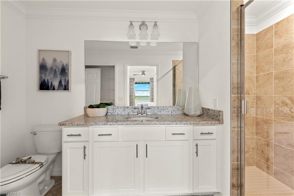 5715 Double Eagle Circle, Unit 4414 Immokalee, FL 34142 - Photo 15 of 20 a bathroom with a granite countertop sink a toilet and a mirror