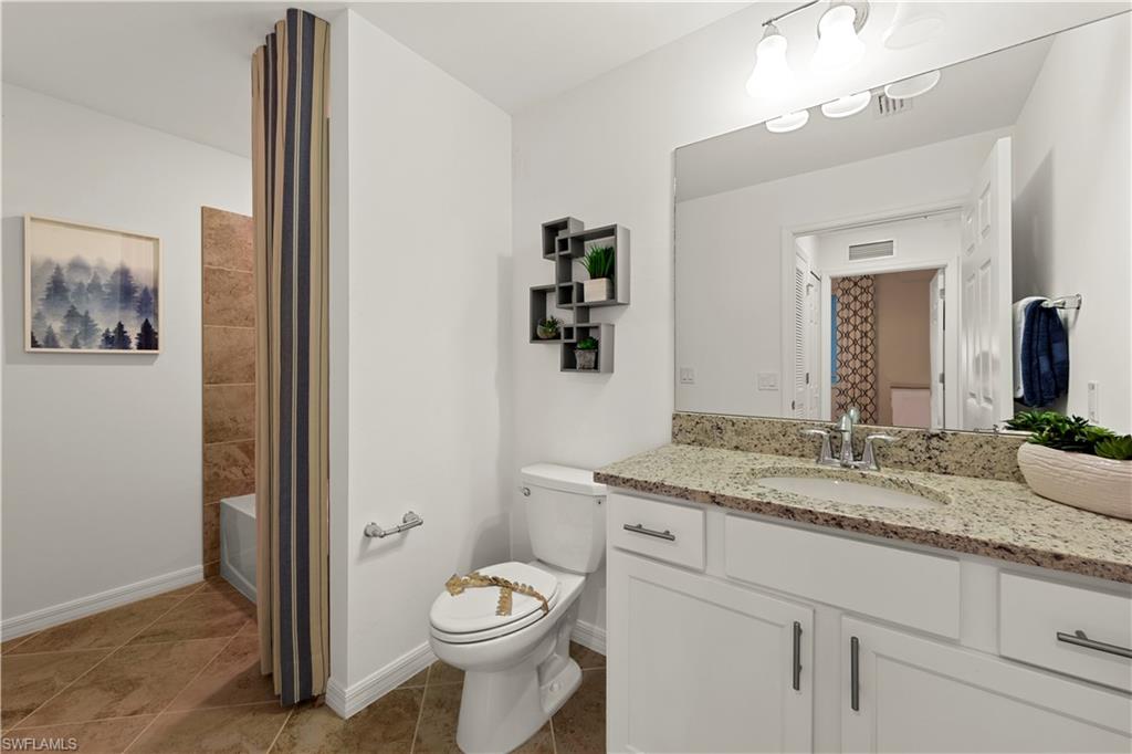 5715 Double Eagle Circle, Unit 4414 Immokalee, FL 34142 - Photo 17 of 20 a bathroom with a granite countertop sink mirror vanity and toilet