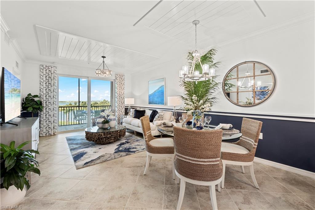 5715 Double Eagle Circle, Unit 4414 Immokalee, FL 34142 - Photo 7 of 20 a dining room with furniture a potted plant and a chandelier