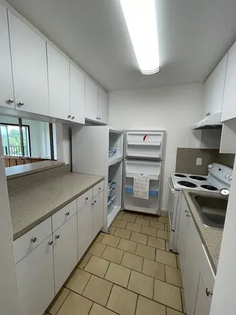 a kitchen with a stove sink and cabinets
