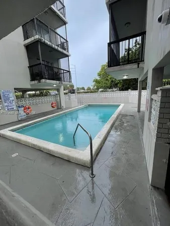 a view of garage with a car parked in it