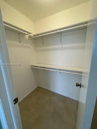 an empty room with a empty space and windows
